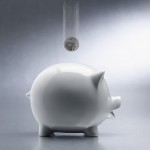 Coin Dropping Into Piggy Bank